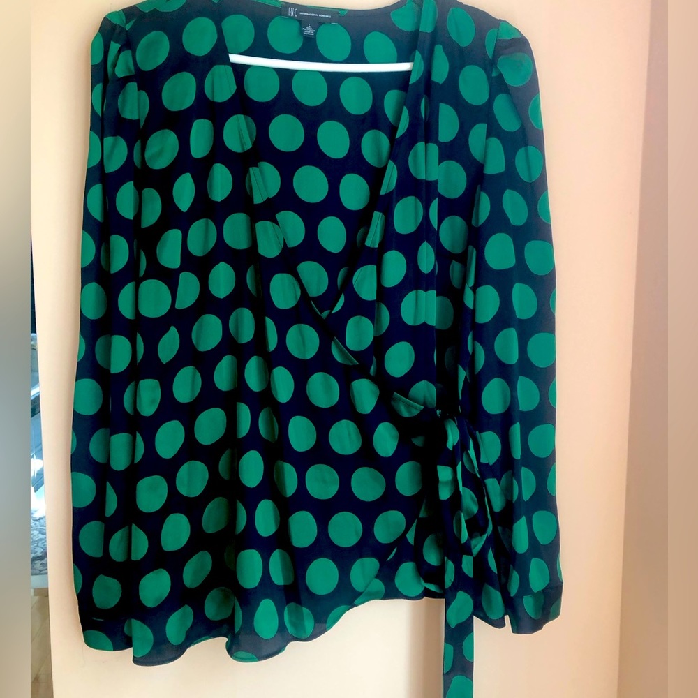 Evening wrap around polka dot blouse in silk fabric.